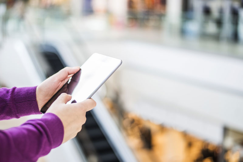 Woman's hands holding on to tablet.